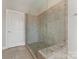 Modern shower with tile surround, glass door, and updated fixtures at 859 Academy St, Charlotte, NC 28205