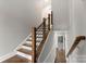 Elegant staircase with wooden railings and hardwood steps leads to the next floor at 859 Academy St, Charlotte, NC 28205