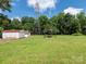 Expansive backyard featuring sheds and a relaxing pergola swing at 876 Stowe Ln, Gastonia, NC 28056