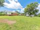 Spacious backyard featuring a well-maintained lawn and mature tree providing ample shade and a single-Gathering home at 876 Stowe Ln, Gastonia, NC 28056