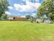 Spacious backyard featuring a brick house, sheds and pergola with seating at 876 Stowe Ln, Gastonia, NC 28056