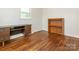 Bedroom with hardwood floors, lots of natural light from two windows, and wooden furniture at 876 Stowe Ln, Gastonia, NC 28056