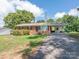 Charming single-Gathering brick house with well-kept lawn, covered parking, and mature landscaping enhance curb appeal at 876 Stowe Ln, Gastonia, NC 28056
