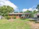 Charming single-story brick home with a well-maintained lawn and covered parking area at 876 Stowe Ln, Gastonia, NC 28056