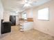 Bright kitchen with white cabinets, black appliances, and an eat-in area at 876 Stowe Ln, Gastonia, NC 28056