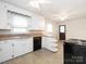 Bright kitchen featuring white cabinetry, black appliances, breakfast bar, and natural light, perfect for cooking and dining at 876 Stowe Ln, Gastonia, NC 28056