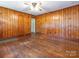 Classic living room with wood paneling and hardwood floors at 876 Stowe Ln, Gastonia, NC 28056