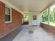 Covered back patio with a brick wall at 876 Stowe Ln, Gastonia, NC 28056