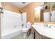 Bathroom with a white bathtub, toilet, and vanity with a mirror above the sink at 9139 Robert Frost Ln, Charlotte, NC 28213