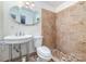 Cozy bathroom featuring tiled shower and a pedestal sink with decorative mirror at 9139 Robert Frost Ln, Charlotte, NC 28213