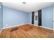 Bedroom with hardwood floors and a window with curtains, allowing for natural light at 9139 Robert Frost Ln, Charlotte, NC 28213