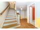 Welcoming foyer with hardwood floors and an open staircase with white railing at 9139 Robert Frost Ln, Charlotte, NC 28213