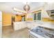 Spacious eat-in kitchen features white cabinets, tiled floors, and bright lighting, creating a welcoming and functional space at 9139 Robert Frost Ln, Charlotte, NC 28213