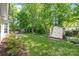 Manicured backyard with lush lawn, storage shed, and mature trees providing shade and privacy at 936 Knightsbridge Rd, Fort Mill, SC 29708