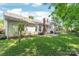 Green backyard with mature trees and a patio area perfect for outdoor entertaining at 936 Knightsbridge Rd, Fort Mill, SC 29708