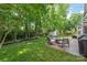 Landscaped backyard featuring a concrete patio with seating and a lush green lawn at 936 Knightsbridge Rd, Fort Mill, SC 29708