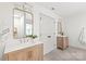 Bright bathroom with double sink vanity, quartz countertops, and gold framed mirrors at 936 Knightsbridge Rd, Fort Mill, SC 29708