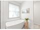 Bright bathroom with soaking tub near window and custom white paint at 936 Knightsbridge Rd, Fort Mill, SC 29708