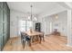 Dining room featuring hardwood floors, wainscoting, chandelier and ample natural light at 936 Knightsbridge Rd, Fort Mill, SC 29708