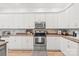 Charming kitchen with stainless steel appliances, ample counter space, and bright white cabinets at 936 Knightsbridge Rd, Fort Mill, SC 29708