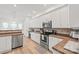 Well-lit kitchen boasts stainless steel appliances, ample counter space, and hardwood flooring at 936 Knightsbridge Rd, Fort Mill, SC 29708