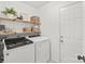 Well-organized laundry room with modern washer and dryer and wooden shelving at 936 Knightsbridge Rd, Fort Mill, SC 29708