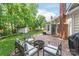 Outdoor patio with fire pit surrounded by chairs, lush lawn, mature trees, and a storage shed at 936 Knightsbridge Rd, Fort Mill, SC 29708
