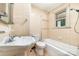 Neutral-toned bathroom with tiled walls, tub/shower, sink and toilet offering a bright and functional space at 952 8Th Ne St, Hickory, NC 28601
