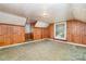 A room with wood-paneled walls, two windows, and carpet flooring, creating a distinctive, rustic charm at 952 8Th Ne St, Hickory, NC 28601