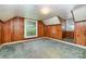 Cozy room with wood-paneled walls, two windows, and carpet flooring, providing a warm and inviting space at 952 8Th Ne St, Hickory, NC 28601