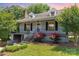 Charming home with landscaped front yard, featuring vibrant roses, inviting entrance, and classic architectural details at 952 8Th Ne St, Hickory, NC 28601