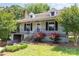 Charming home with landscaped front yard, featuring vibrant roses, inviting entrance, and classic architectural details at 952 8Th Ne St, Hickory, NC 28601