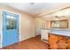 Open kitchen area with blue door, wood cabinets and view to the living room offering convenient living space at 952 8Th Ne St, Hickory, NC 28601