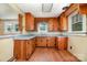 An efficient u-shaped kitchen layout showcasing wood cabinetry and ample counter space, illuminated by natural light at 952 8Th Ne St, Hickory, NC 28601