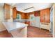 Vintage kitchen featuring wood cabinets, a peninsula counter, and unique built-in storage for a rustic feel at 952 8Th Ne St, Hickory, NC 28601