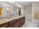 Bathroom featuring double sinks with granite countertop, ample storage, and a glass-enclosed shower for a spa-like experience at 1036 Squire Dr, Fort Mill, SC 29707