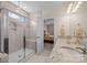 Modern bathroom with a spacious glass shower, tiled walls, and a view into a brightly lit adjoining bedroom at 1036 Squire Dr, Fort Mill, SC 29707