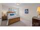 Cozy bedroom with wooden bed frame, neutral walls, and natural light from the window at 1036 Squire Dr, Fort Mill, SC 29707