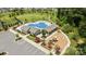 Aerial view of a community pool with a playground, lounge chairs, and landscaped grounds at 1036 Squire Dr, Fort Mill, SC 29707