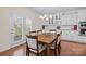 Bright dining room with built-in cabinets, elegant chandelier, and access to the outdoors through french doors at 1036 Squire Dr, Fort Mill, SC 29707