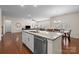 Modern kitchen island with granite countertop overlooks the open-concept living and dining areas, great for entertaining at 1036 Squire Dr, Fort Mill, SC 29707