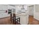 Modern kitchen island with white cabinets, stainless steel appliances, and hardwood floors at 1036 Squire Dr, Fort Mill, SC 29707