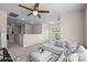 Spacious bonus room with ceiling fan, white sectional sofa, and neutral carpeting at 1036 Squire Dr, Fort Mill, SC 29707