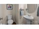 Cozy powder room with a pedestal sink, modern fixtures, and stylish decor that complements the home's aesthetic at 1036 Squire Dr, Fort Mill, SC 29707