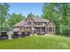 Expansive backyard featuring a pool, outdoor seating and meticulously maintained landscaping at 1056 James Madison Dr, Matthews, NC 28104