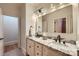 Bright bathroom with double sink vanity featuring granite countertops and black modern fixtures at 1056 James Madison Dr, Matthews, NC 28104