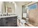 Bathroom featuring gray cabinets, a clear glass shower, and a large mirror at 1056 James Madison Dr, Matthews, NC 28104