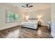 Bedroom with hard wood floors, a ceiling fan, and large windows with shutters at 1056 James Madison Dr, Matthews, NC 28104