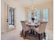 Dining room with modern lighting, a round table, and plantation shutters at 1056 James Madison Dr, Matthews, NC 28104