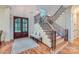 Elegant foyer boasts hardwood floors, staircase with decorative iron railings, and a stylish entry bench at 1056 James Madison Dr, Matthews, NC 28104